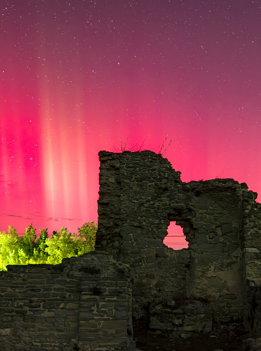 La noche del 10 al 11 de octubre no defraudó y tal como se prevenía aparecieron las auroras, a primera hora de la noche una parte del cielo cambió de color, pero ya pasada la medianoche aparecieron estos rayos verticales, que los pude capturar con el primer plano de las ruinas de la vieja iglesia, el verde de los árboles iluminados por el farol de la carretera añadió un poco más de color y profundidad a la imagen.
