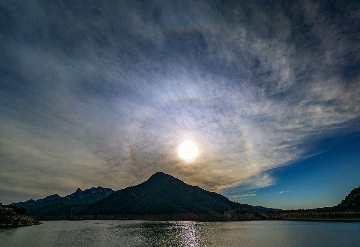 Siempre gusta fotografiar un halo solar y si es doble mejor, lo capturé en el embalse de La Baells de la cuenca del río Llobregat, un embalse que últimamente ha recuperado un poco el  nivel del agua, el halo parecía salir de una zona conocida como Canals de Sant Miquel. 
