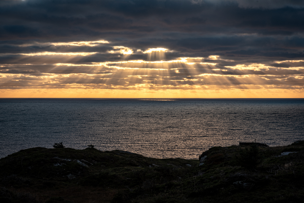 Puesta de sol en el Mar del Norte con algunos rayos visibles entre las nubes
